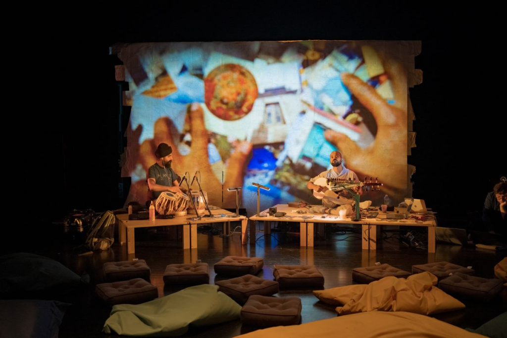 a musician playing the drums and a musician playing a sarod