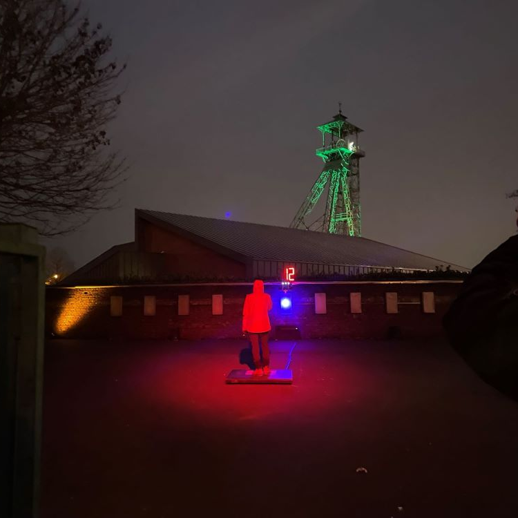 member of public on a footpad playing a life-size light game
