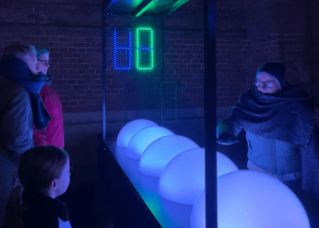 people admiring Light Games installation 