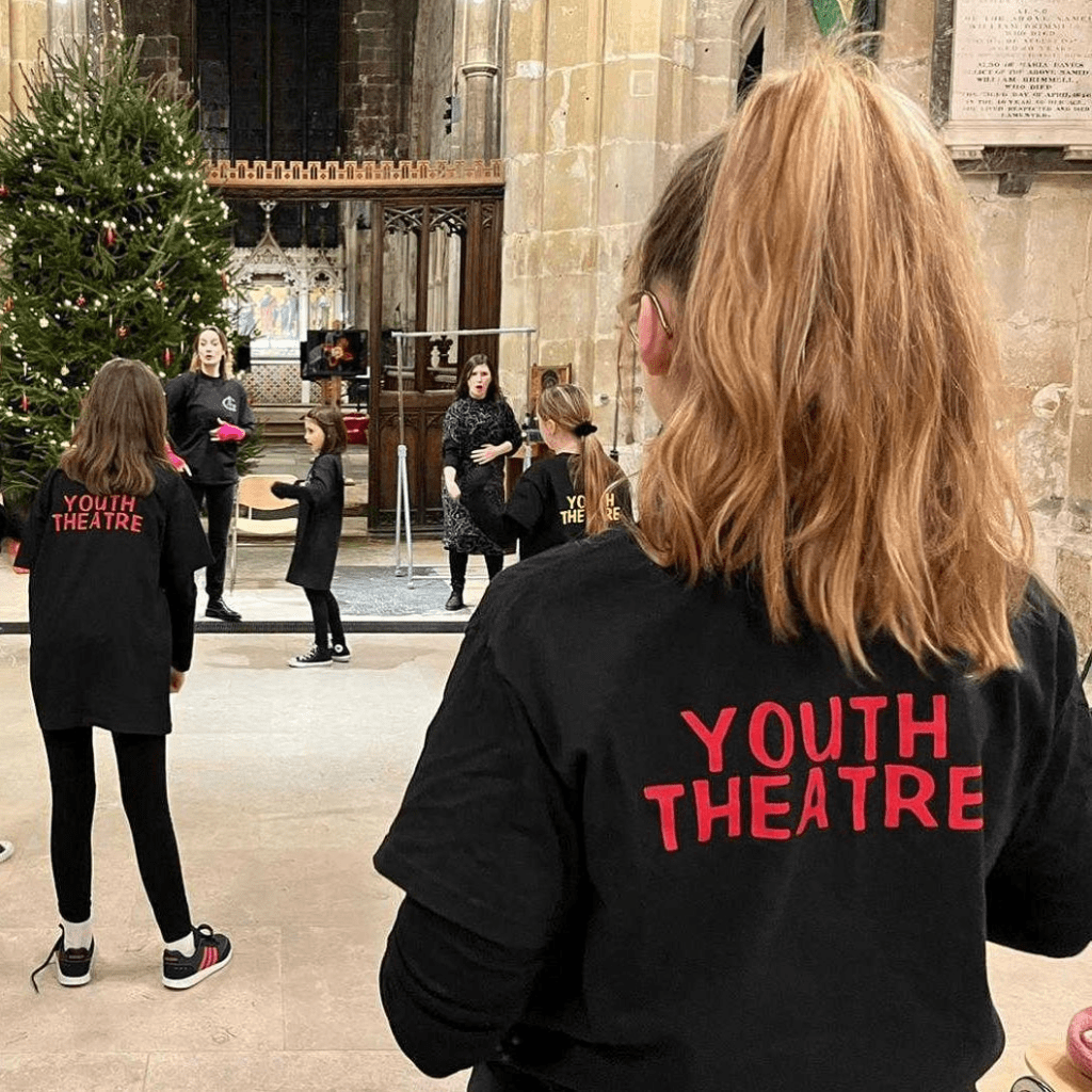 members of Youth Theatre preparing for a performance in St Mary De Crypt